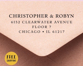 May include: A brown paper envelope with a white label that reads "CHRISTOPHER & ROBYN 6152 CLEARWATER AVENUE FLOOR 7 CHICAGO • IL 61217". A yellow circle with the text "FREE SHIPPING" is on the bottom left corner of the envelope.