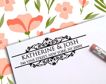 May include: A black and white return address stamp with a decorative flourish design. The text reads "Katherine & Josh 546 Vine Street, New York, NY 20001".