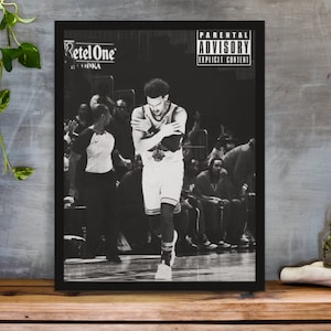 May include: Black and white photograph of a basketball player in a game. The player is wearing a jersey with the number 23 and the text "RetelOne" is visible on the jersey. The photo has a parental advisory label with the text "Parental Advisory Explicit Content".