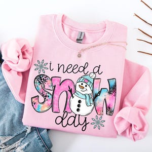 I Need A Snow Day Sweatshirt, Snowman Winter T-Shirt, Freezing Season Hoodie, Xmas Season Clothing, Cold Sweatshirt, Pink Snowman Sweatshirt