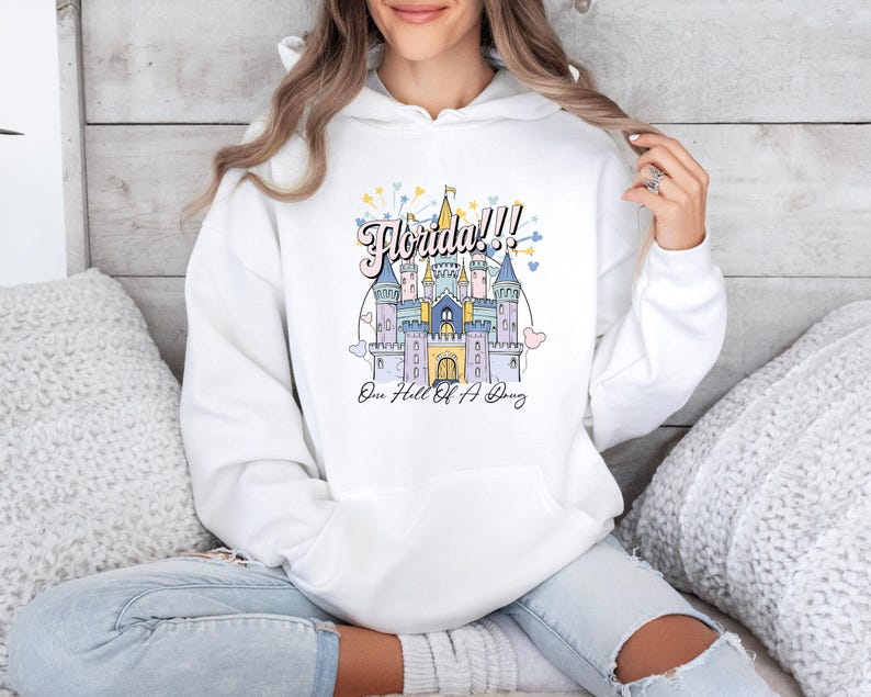 May include: White hoodie with a graphic of a pink castle with the text "Florida!! One Hell Of A Day" printed on the front.