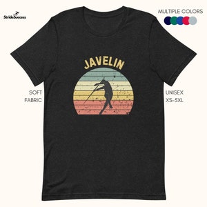 May include: A black t-shirt featuring a vintage-style graphic of a person throwing a javelin in front of a sunset. The text "JAVELIN" is printed in white above the graphic.