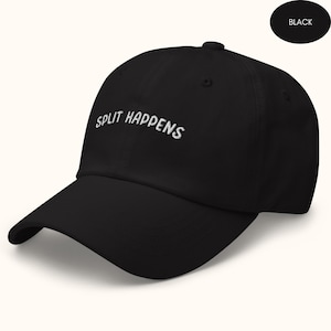 May include: A black baseball cap with white embroidered text that reads "SPLIT HAPPENS".