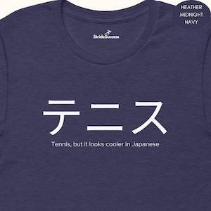May include: Heather midnight navy t-shirt with white Japanese text that reads "Tennis". Below the text is the phrase "Tennis, but it looks cooler in Japanese". The shirt also has the "StrideSuccess" logo.