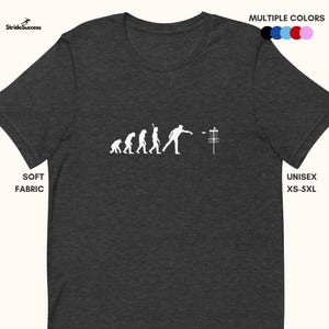 May include: A dark heather grey t-shirt featuring a white graphic of the evolution of man culminating in a person throwing a disc into a disc golf basket.