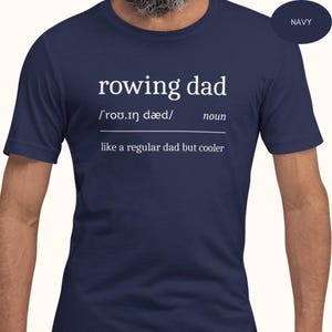 May include: Navy blue t-shirt with white text that reads "rowing dad /rou.in daed/ noun like a regular dad but cooler"