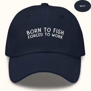 May include: A navy blue baseball cap with white embroidery that reads "Born to Fish Forced to Work".