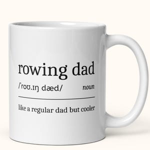 May include: White ceramic coffee mug with black text that reads "rowing dad /'rov.in daed/ noun like a regular dad but cooler"