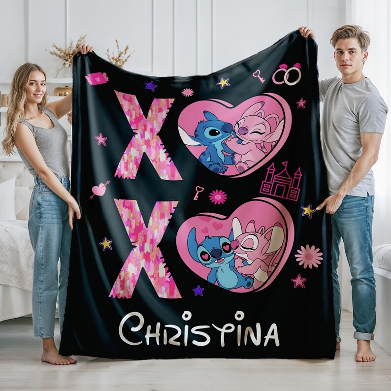 May include: Black fleece blanket with a pink and blue cartoon couple, a pink heart with the letters XOXO, and the name Christina.