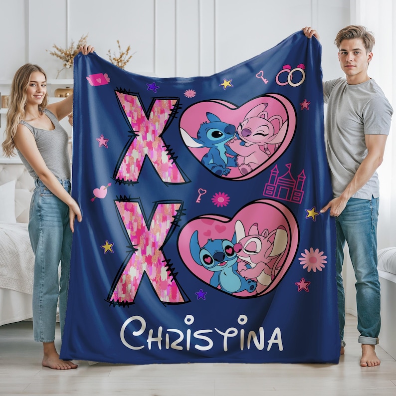May include: Blue fleece blanket with a pink and white XO design, featuring Stitch and Angel from Lilo & Stitch. The blanket has a pink heart with the characters kissing and the name "Christina" printed on the bottom.