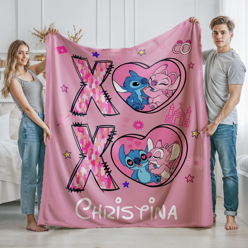 May include: Pink fleece blanket with a pink and white patterned X and a pink and white patterned O. The blanket features two hearts with Stitch and Angel from Lilo & Stitch kissing. The text "CHRISTINA" is printed on the blanket.