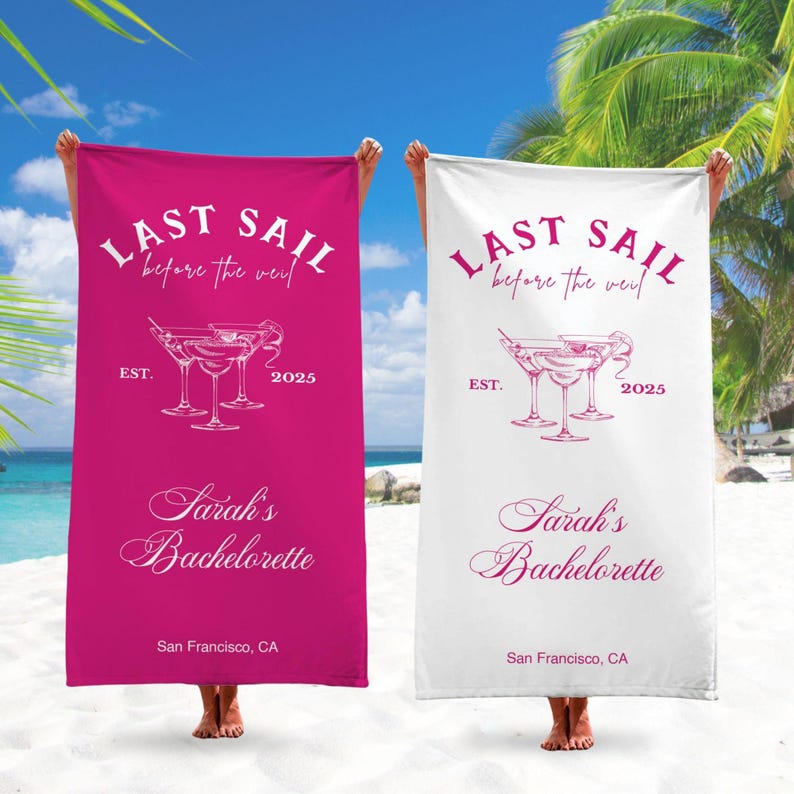 May include: Two pink and white beach towels with the text "Last Sail Before the Veil" and "Sarah's Bachelorette" with a martini glass graphic. The towels are on a beach with a palm tree in the background.