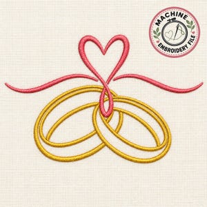 May include: A machine embroidery design featuring two interlocking gold rings topped with a pink heart shape formed by a continuous line. The design includes a circular logo in the top right corner with the text MACHINE EMBROIDERY FILE.