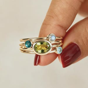 May include: A set of three ceramic nesting bowls in graduating sizes. The bowls feature a speckled, matte finish in shades of cream, beige, and brown. The largest bowl measures approximately 8 inches in diameter.