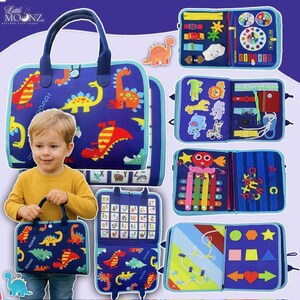 May include: A blue fabric activity bag with a dinosaur theme. The bag has a handle and features colorful dinosaur illustrations. Several activity panels with various interactive elements are displayed.