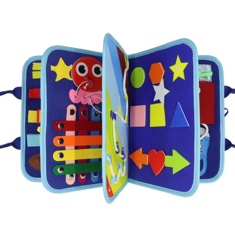 May include: A blue felt activity book for toddlers, featuring various shapes, colors, and interactive elements. Includes a red octopus, colorful bars, and geometric shapes like stars, hearts, and arrows. The book is designed to promote learning and fine motor skills.