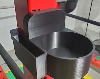 May include: A black 3D printed holder with a cup and a small compartment attached to a red metal weightlifting rack.