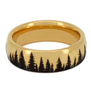 May include: A gold wedding band with a black silhouette of a forest etched into the band.