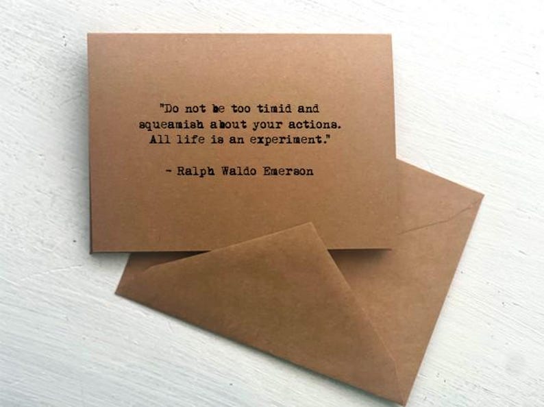 May include: A brown card and envelope set. The card features the quote "Do not be too timid and squeamish about your actions. All life is an experiment." by Ralph Waldo Emerson, printed in black.