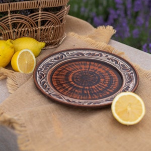 May include: A set of three ceramic mugs with a speckled, matte finish. The mugs are in shades of cream, light brown, and dark brown. Each mug has a simple, minimalist design, perfect for coffee or tea.