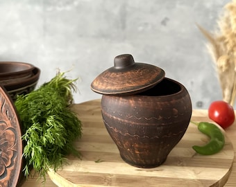 Small red clay storage jar, Rustic terracotta spice container, Unglazed earthenware pot, Traditional handmade artisan kitchen ceramic pot