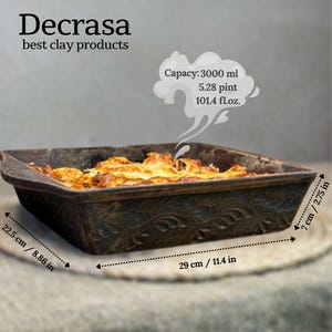 May include: A dark brown rectangular clay baking dish with an embossed leaf pattern on the sides, containing cooked food. Text reads Decrasa best clay products, Capacy: 3000 ml, 5.28 pint, 101.4 fl.oz. Dimensions are 22.5 cm/8.86 in by 29 cm/11.4 in by 7 cm/2.75 in.