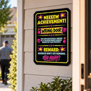 May include: A rectangular black sign with yellow and pink text and graphics. It reads: NEEEEW ACHIEVEMENT! WRONG DOOR. YOU HAVE SUCCESSFULLY ARRIVED AT A LOCATION WHERE NOBODY REQUESTED YOUR PRESENCE. REWARD: ASSHOLES DON'T GET REWARDS. GO AWAY!