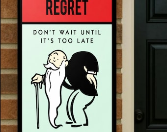 May include: A framed sign with a red top section that reads "REGRET" in black capital letters. Below, the sign says "DON'T WAIT UNTIL IT'S TOO LATE." The image features a cartoon of an elderly man with a long white beard and a black figure.