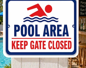May include: A rectangular pool area sign with a white background and a blue border. The sign features a red swimmer icon above the words "POOL AREA" and "KEEP GATE CLOSED" in bold blue and red text.