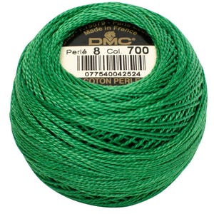 May include: A ball of bright green DMC Perl&eacute; cotton thread, color 700, with a label indicating it's made in France. The thread is tightly wound, showcasing its texture and color. Ideal for embroidery and needlework projects.