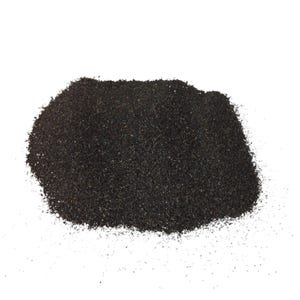 May include: A close-up of a pile of black sand. The sand is fine-grained and has a slightly rough texture.