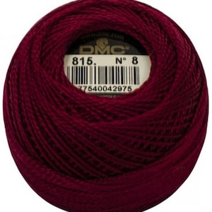 May include: A ball of DMC embroidery thread in a deep burgundy color. The label shows the number 815 and the number 8. The barcode and the DMC logo are also visible.