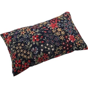 May include: A rectangular pillow with a dark blue background and a floral pattern in shades of red, yellow, and green.