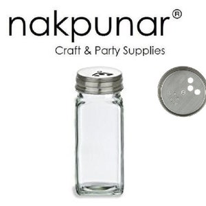 May include: A clear glass spice jar with a silver lid and a shaker top. The lid has a small hole in the center and four smaller holes around it. The jar is empty.