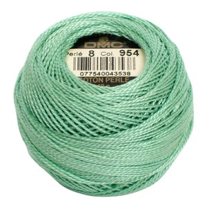 May include: A ball of DMC Perl&eacute; cotton thread in a soft, mint green color. The label indicates it is size 8, color 954, and COTON PERLE. The thread is tightly wound, showing the texture of the individual strands.