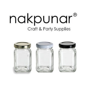 May include: Three glass jars with square bodies and different colored lids. The lids are silver, white, and black. The jars are empty and ready to be filled.