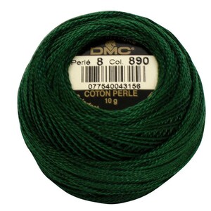 May include: A ball of dark green DMC Perl&eacute; cotton thread, Col. 890, weighing 10 g. The label displays the DMC logo, thread details, and a barcode. The thread is tightly wound, showcasing its texture and color.