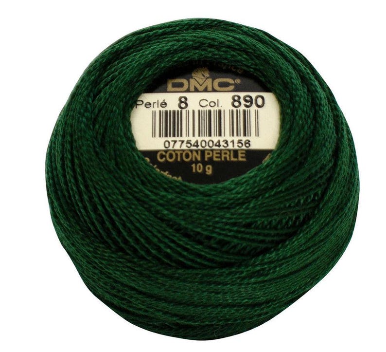 May include: A ball of dark green DMC Perl&eacute; cotton thread, Col. 890, weighing 10 g. The label displays the DMC logo, thread details, and a barcode. The thread is tightly wound, showcasing its texture and color.