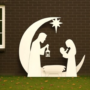 May include: A white silhouette of the Nativity scene, including Mary, Joseph, and baby Jesus, set against a crescent moon and star. The figures are in front of a dark brick wall and green grass.