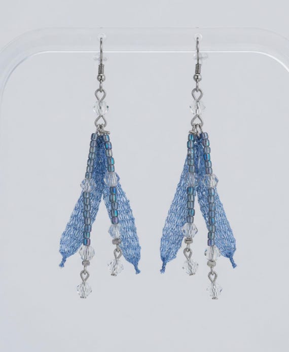 Crystal feather look dangling earrings in pale blue