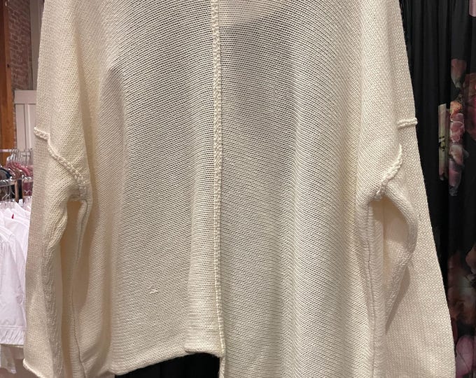 One size  cream color asymmetrical sweater with one pocket