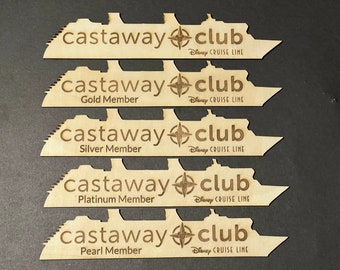 May include: Wooden Castaway Club membership tags in the shape of a cruise ship. Each tag features the "Castaway Club" logo, a compass rose, and "Disney Cruise Line." The tags are labeled "Gold Member," "Silver Member," "Platinum Member," and "Pearl Member."