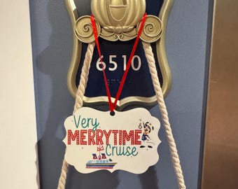 May include: A white rectangular sign with scalloped edges hangs from a gold-colored carriage-shaped door plaque labeled 6510. The sign features the text Very MERRYTIME Cruise in red and green, a small cartoon character, and a cruise ship graphic.