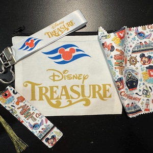 May include: A collection of Disney Treasure themed items. Includes a white pouch with a black zipper, a lanyard, a bookmark with a gold tassel, and a patterned cloth. The items feature Mickey Mouse and cruise ship designs.