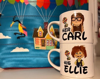 May include: Two white ceramic mugs stacked on top of each other, each with a cartoon illustration and text. The top mug says "Her Carl" and the bottom mug says "His Ellie". A blue tote bag with a colorful hot air balloon design is in the background.