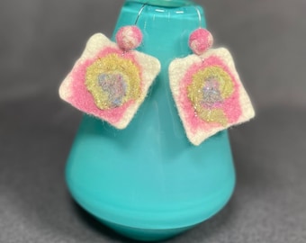 Earring pink and gold with bits of purple and sparkle wet felted on a white background light weight earring fun to wear and great gifts