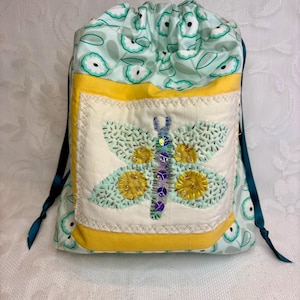 May include: A rustic wooden sign with the text "Welcome to our home" in white lettering. The sign is rectangular and features a distressed finish, suggesting a vintage or farmhouse style. It is likely designed for indoor or outdoor display.