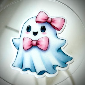 May include: A cute cartoon ghost with a pink bow and a pink bow tie. The ghost is white with blue shading and has a happy expression.