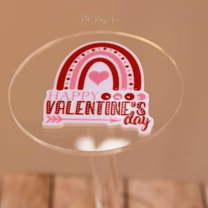 May include: A white acrylic sticker with a red and pink rainbow design and the text "Happy Valentine's Day".