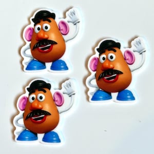 May include: Three Mr. Potato Head stickers. Each sticker features a cartoon potato character with an orange face, black mustache, black hat, and blue shoes. The character is waving with white gloves and has pink ears.